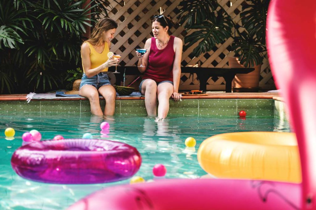 Girls relaxing by the swimming pool