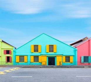 Colorful exterior industry warehouse in Singapore in day times with street foreground and blue sky background. Picture for add text message. Backdrop for design art work.