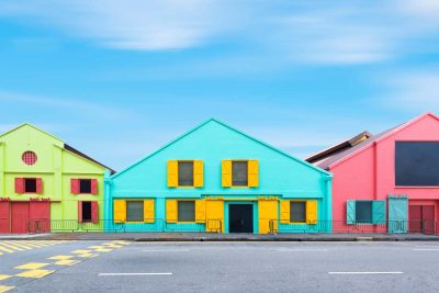 Colorful exterior industry warehouse in Singapore in day times with street foreground and blue sky background. Picture for add text message. Backdrop for design art work.