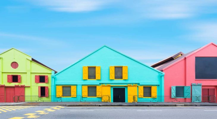 Colorful exterior industry warehouse in Singapore in day times with street foreground and blue sky background. Picture for add text message. Backdrop for design art work.