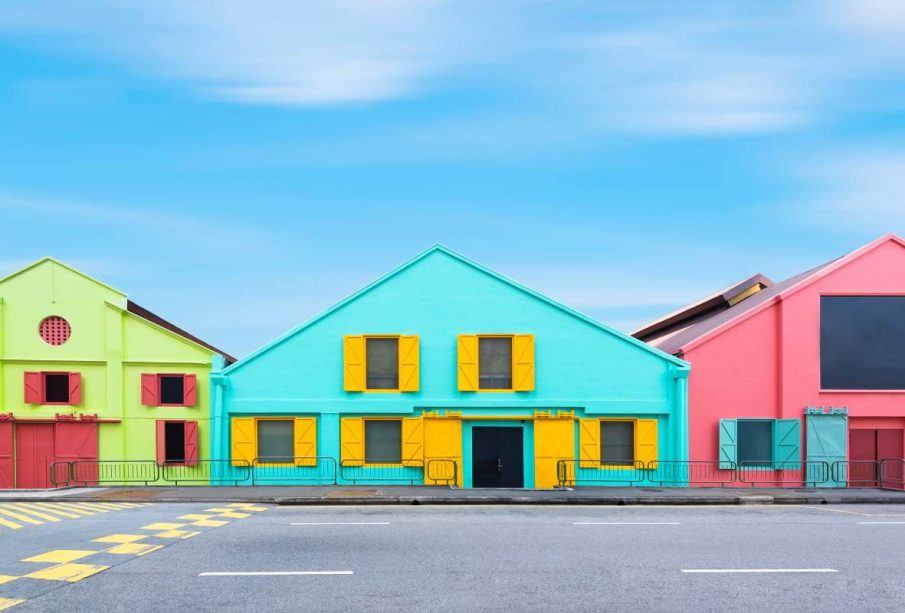 Colorful exterior industry warehouse in Singapore in day times with street foreground and blue sky background. Picture for add text message. Backdrop for design art work.