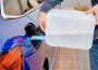 Close up man filling a diesel engine fluid from canister into the tank of blue car. Diesel exhaust fluid for reduction of air pollution. Environmental friendly and eco solution