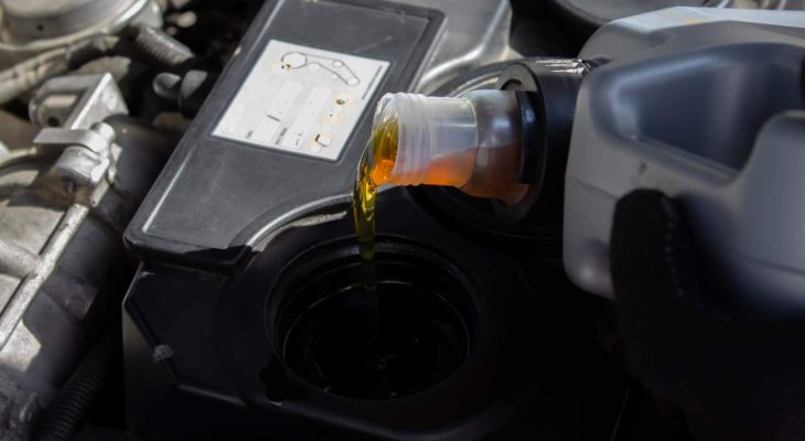 Refueling and pouring oil quality into the engine motor car Transmission and Maintenance Gear .Energy fuel concept. selective focus